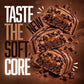 Warrior Crunch Fudge Brownie protein bars, three pieces cut open to show the soft dough and caramel centre with chocolate pieces, alongside the tagline 'Taste the New Soft Core'.