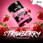 A tub of Warrior Serious Protein Strawberry Milkshake flavor is shown floating at an angle against a pink background with strawberries around it and large white text reading 'STRAWBERRY' and 'Milkshake Flavoured'.