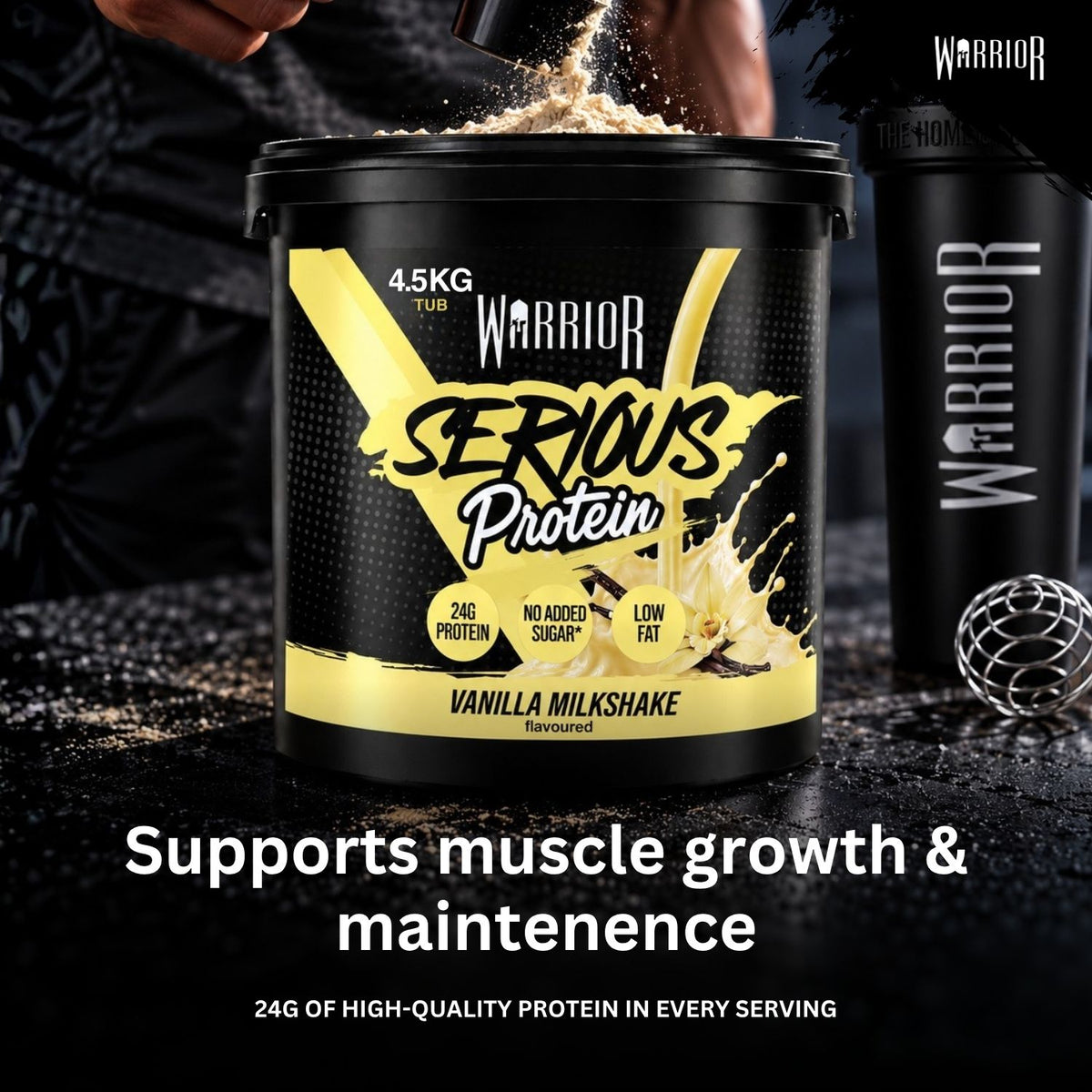 A large black tub of Warrior Serious Protein Vanilla Milkshake powder is shown on a dark surface with powder splashing from the lid. A person's hands and torso are partially visible behind it, along with a black Warrior shaker bottle and a small metal scoop.