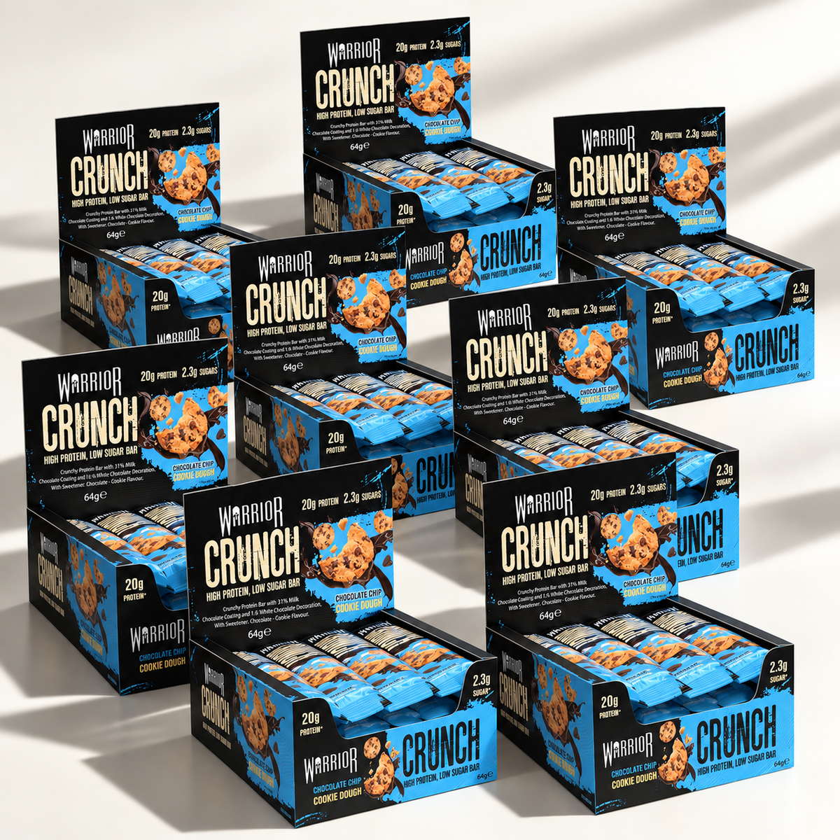 Eight Warrior CRUNCH Chocolate Chip Cookie Dough protein bar display boxes arranged in an overlapping cluster on an off-white background, with red and black packaging and dramatic studio lighting.